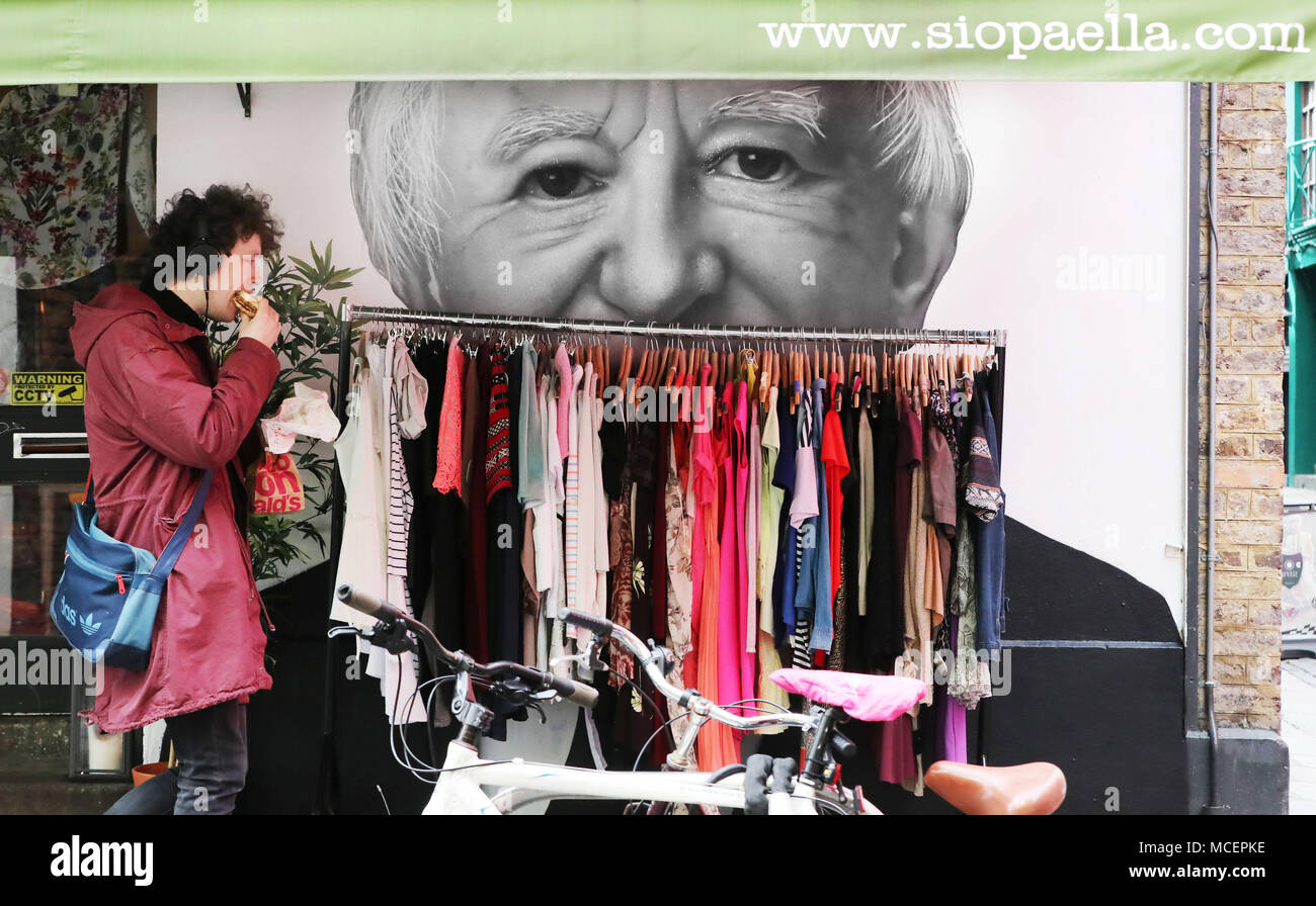 A man walks past a Mural of Irish President Michael D Higgins by Subset collective in the Temple Bar area of Dublin. The mural is part of the #Greyareaproject, a protest against a recent Dublin City council clamp down on Street art. Stock Photo