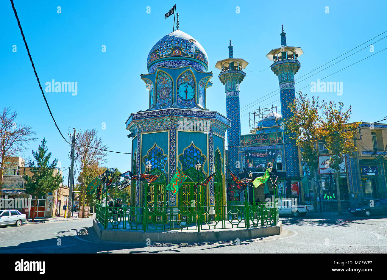RAYEN, IRAN - OCTOTBER 16, 2017: The circular traffic in Inqilab (Revolution) square with Shia Shrine to Martyr of Iran-Iraq War in the middle and Jam Stock Photo