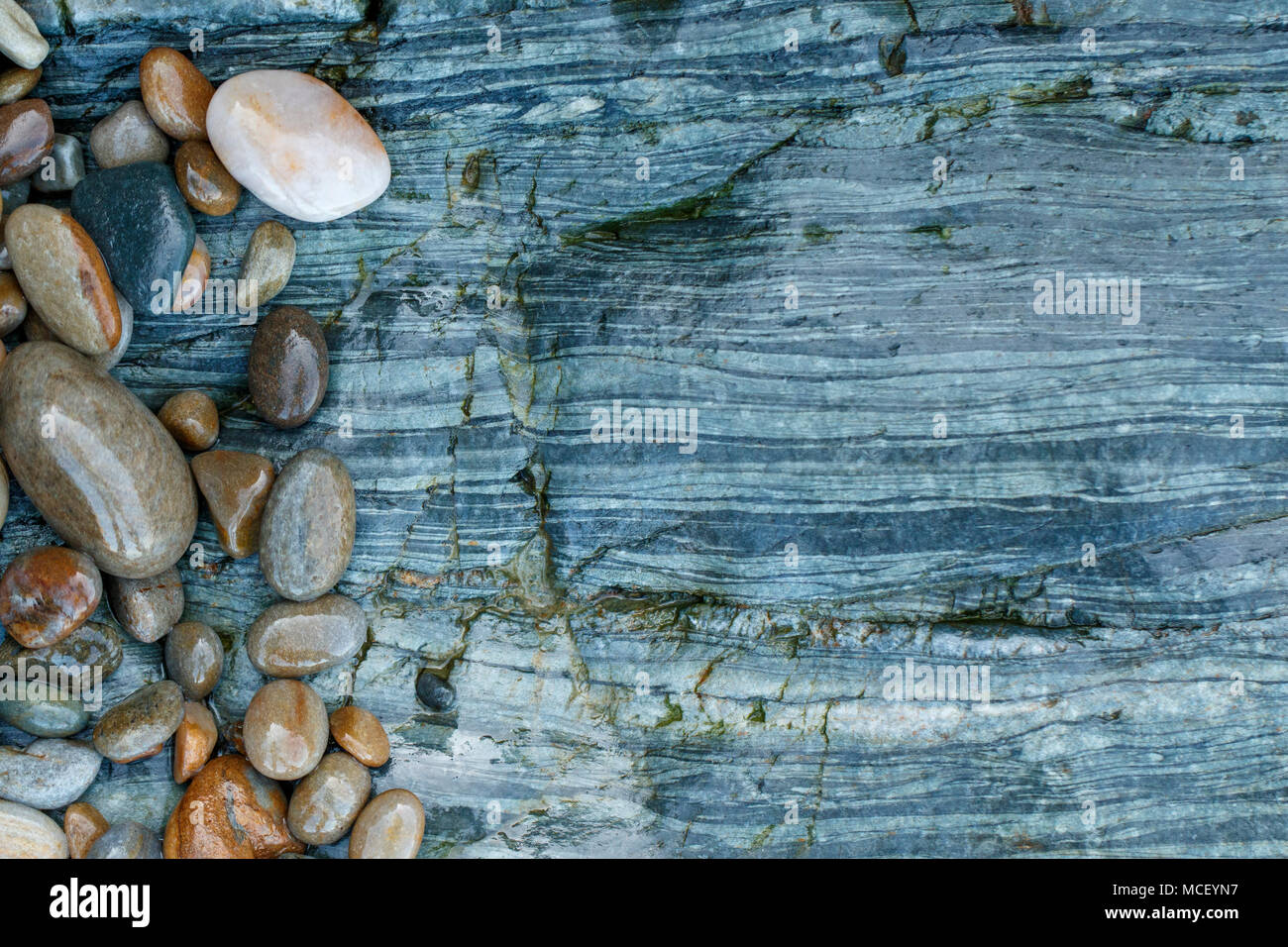 Composition of stone texture and pebble stones with copyspace, Playa del Silencio, Asturias, Spain Stock Photo