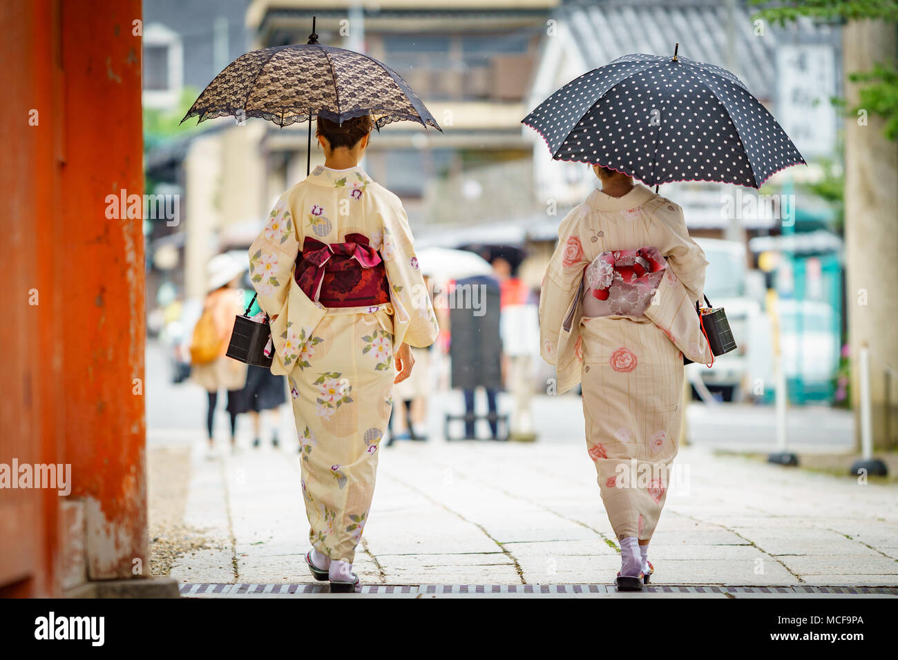 Rear view of japanese women in kimono walking with umbrella Stock Photo -  Alamy
