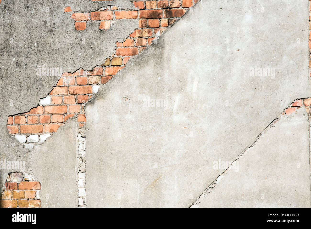 Old plastered wall with red bricks Stock Photo