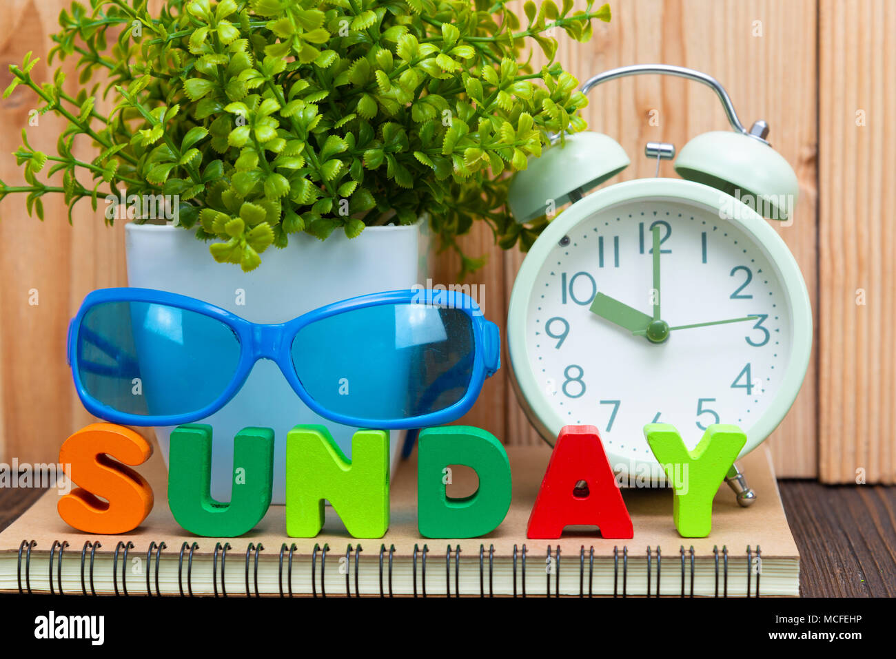 SUNDAY letters text and notebook paper, alarm clock and little ...