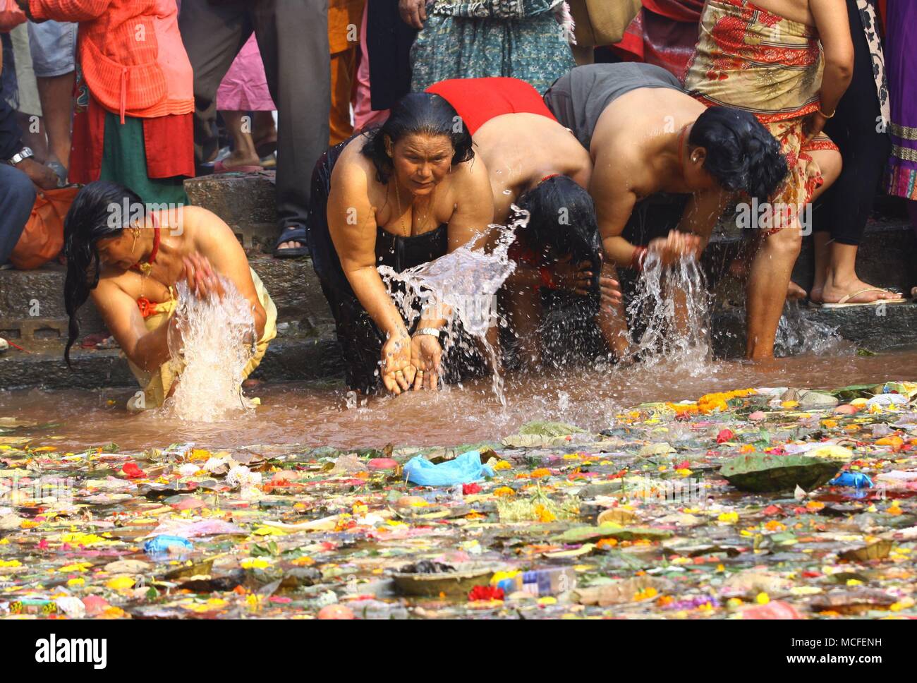 Kathmandu, Nepal. 16th Apr, 2018. Devotees take holy bath at a pond in