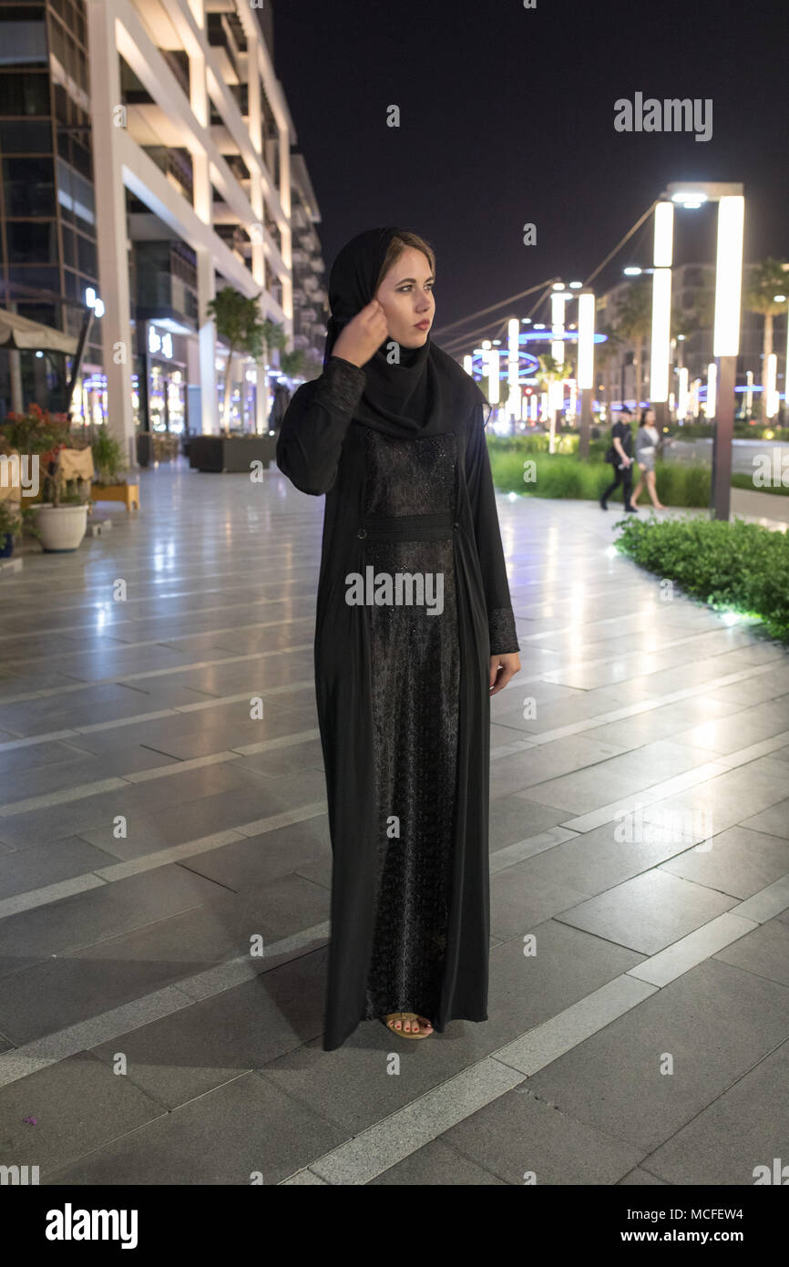 Muslim woman wearing in a hijab walks in the night city Stock Photo - Alamy