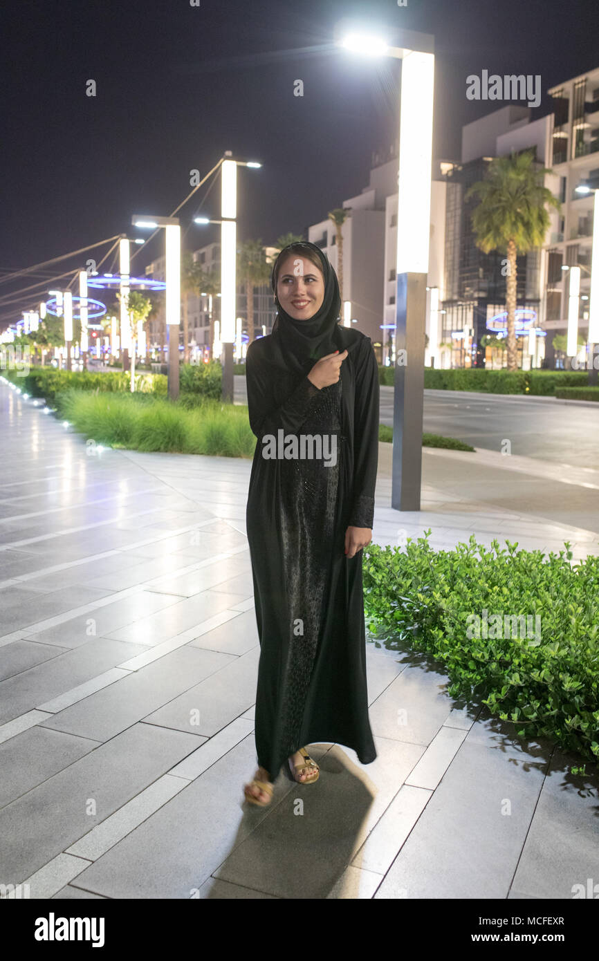 Muslim woman wearing in a hijab walks in the night city Stock Photo - Alamy