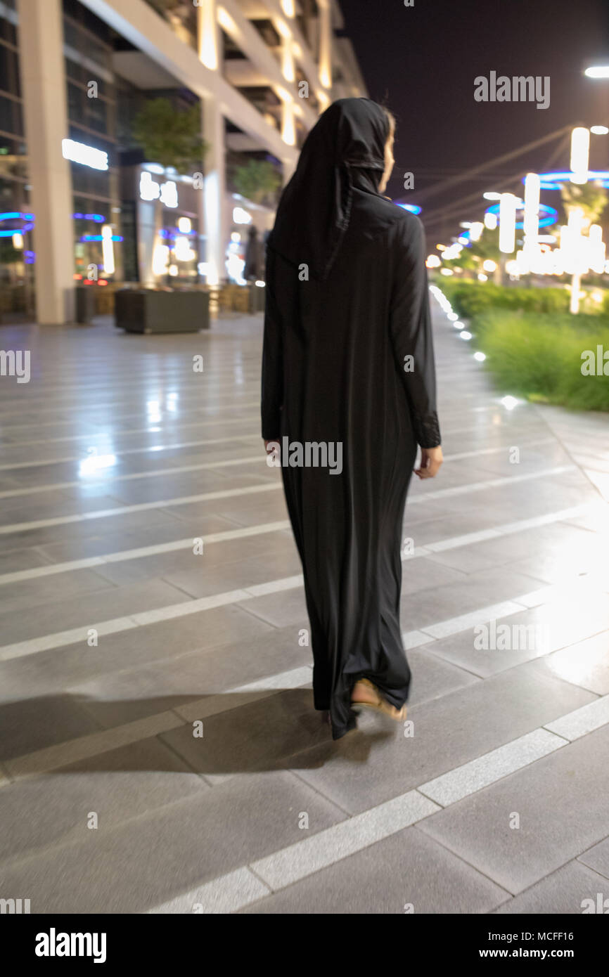Muslim woman wearing in a hijab walks in the night city Stock Photo - Alamy