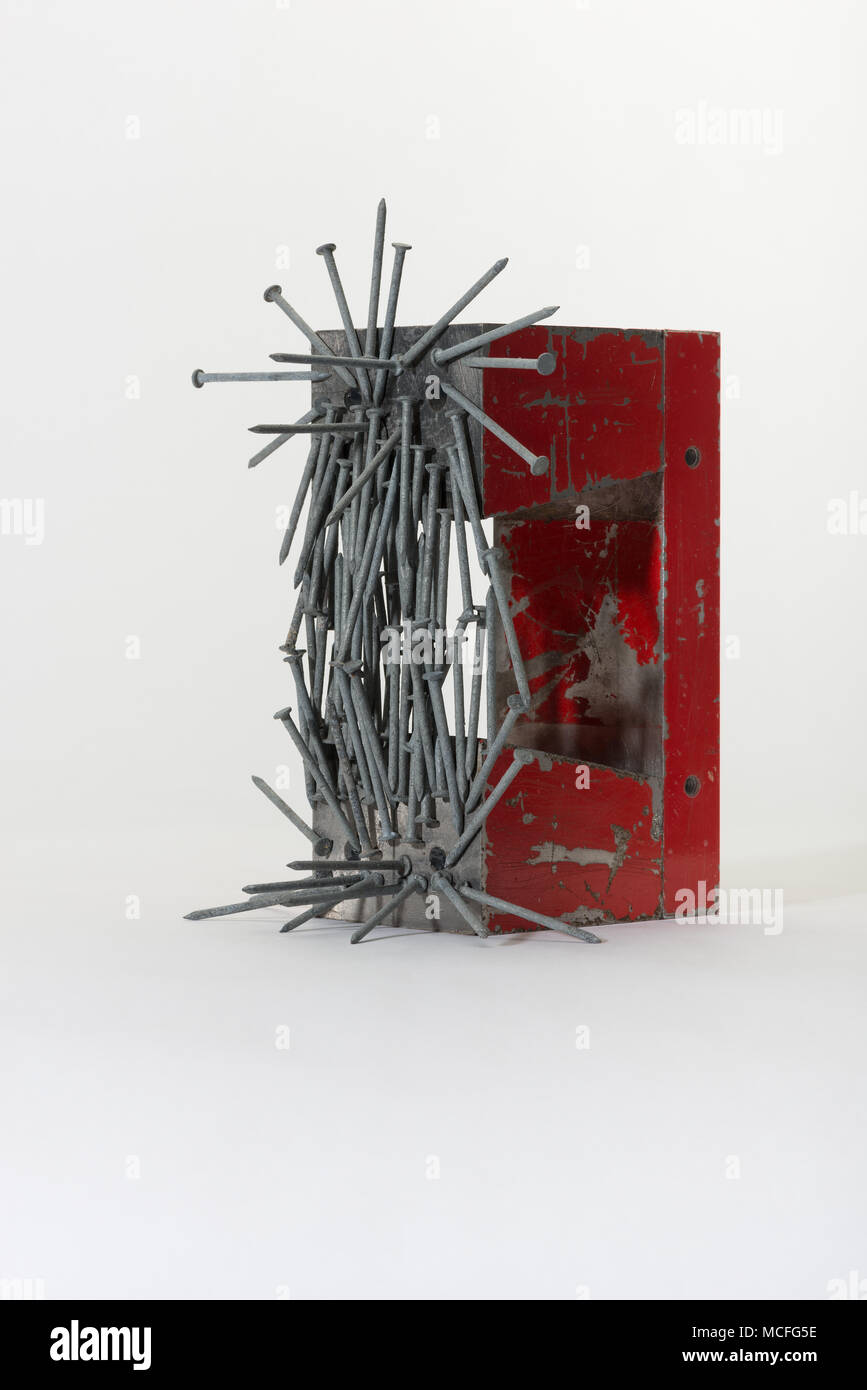 Large industrial powerful horseshoe magnet made from component parts  attracting iron nails, galvanised staples, clouts demonstrating magnetic  field Stock Photo - Alamy