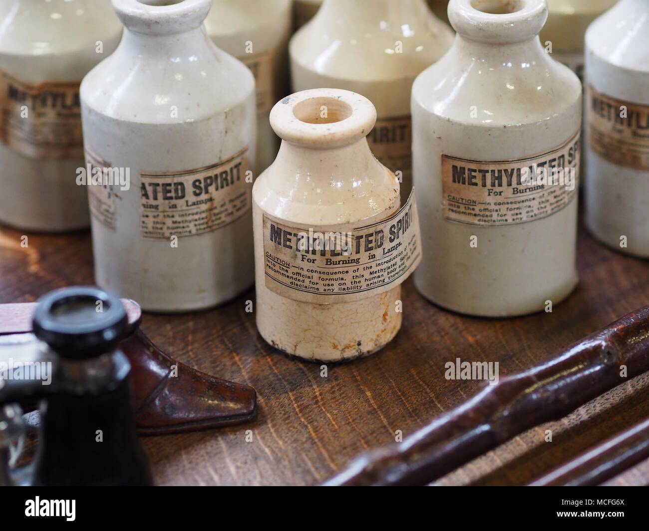Methylated spirit white glass bottles at an antiques fair Stock Photo