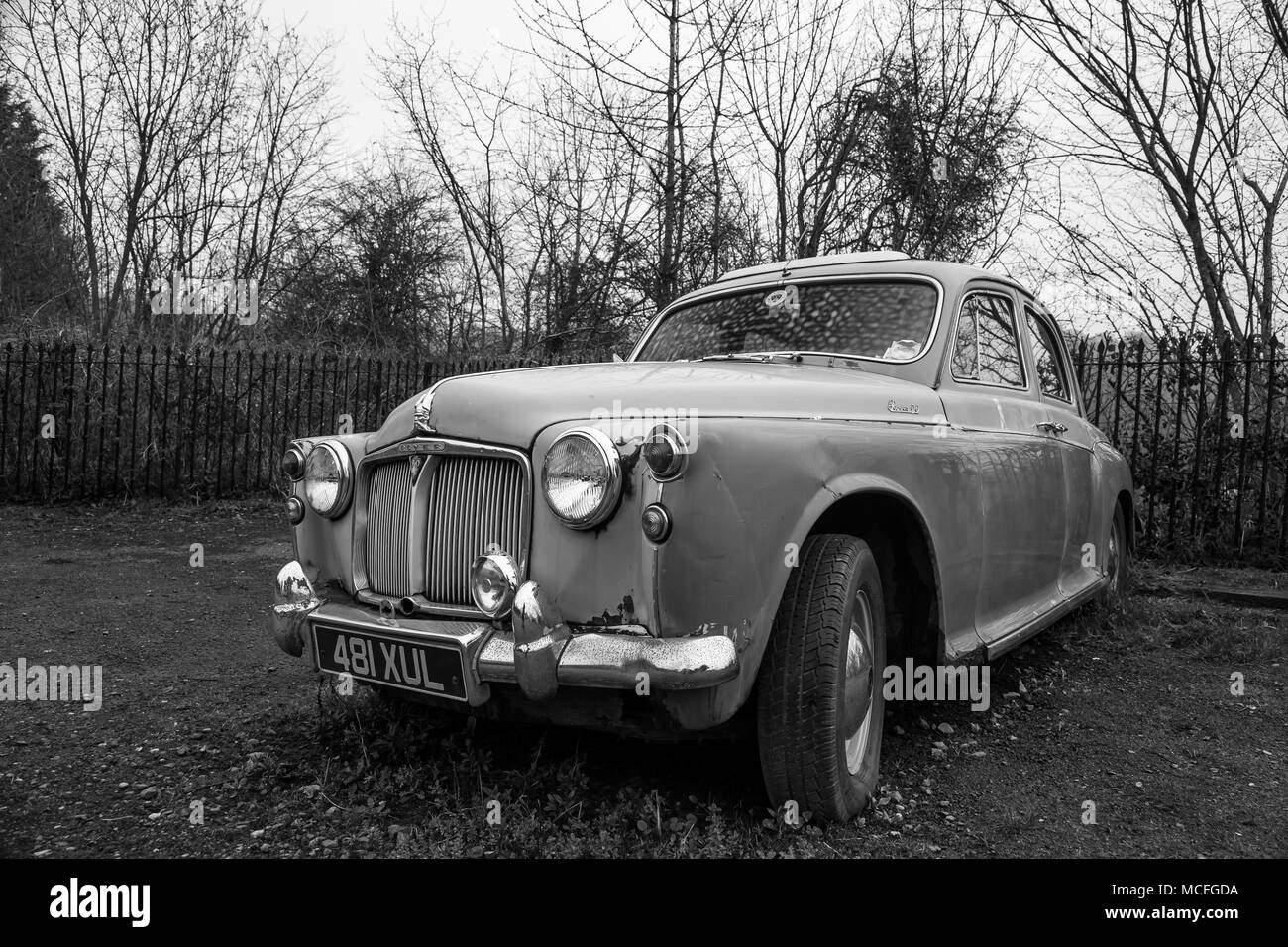 Monochrome, isolated Rover P90 motor car, abandoned relic, parked in a deserted UK car park. Stock Photo