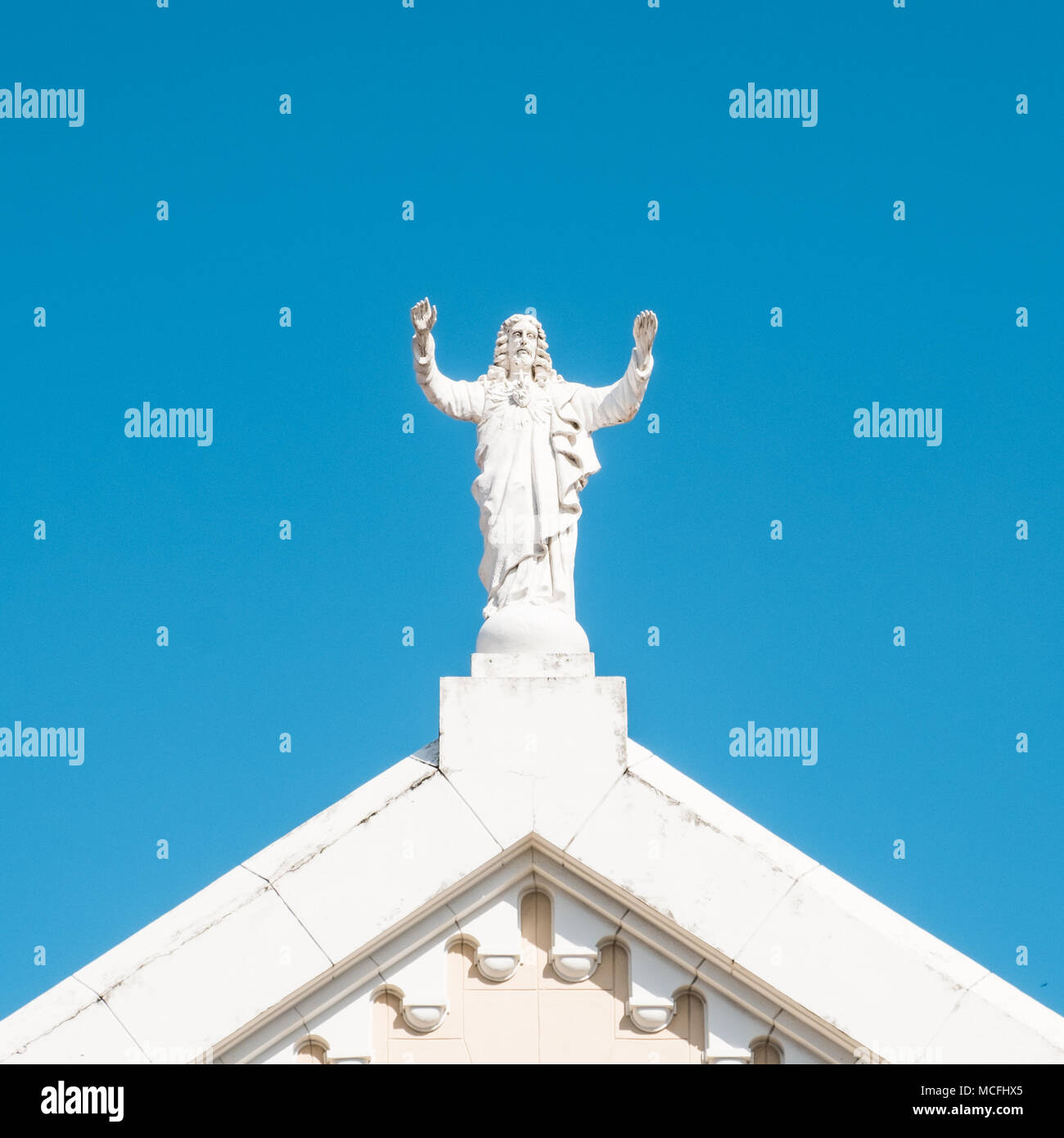 Jesus Christ sculpture on church roof Jesus statue isolated Stock