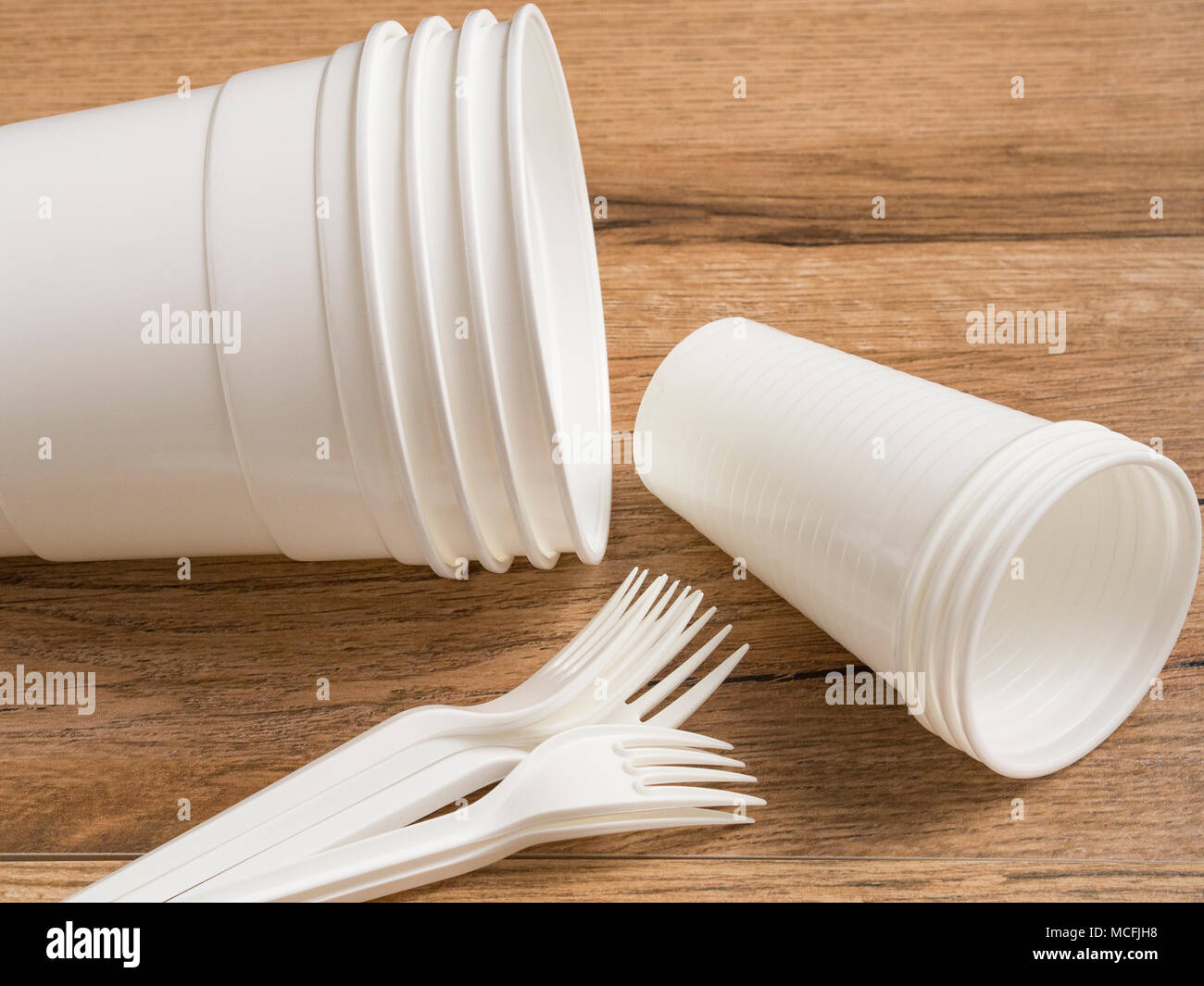 Plastic ware on wood background Stock Photo Alamy