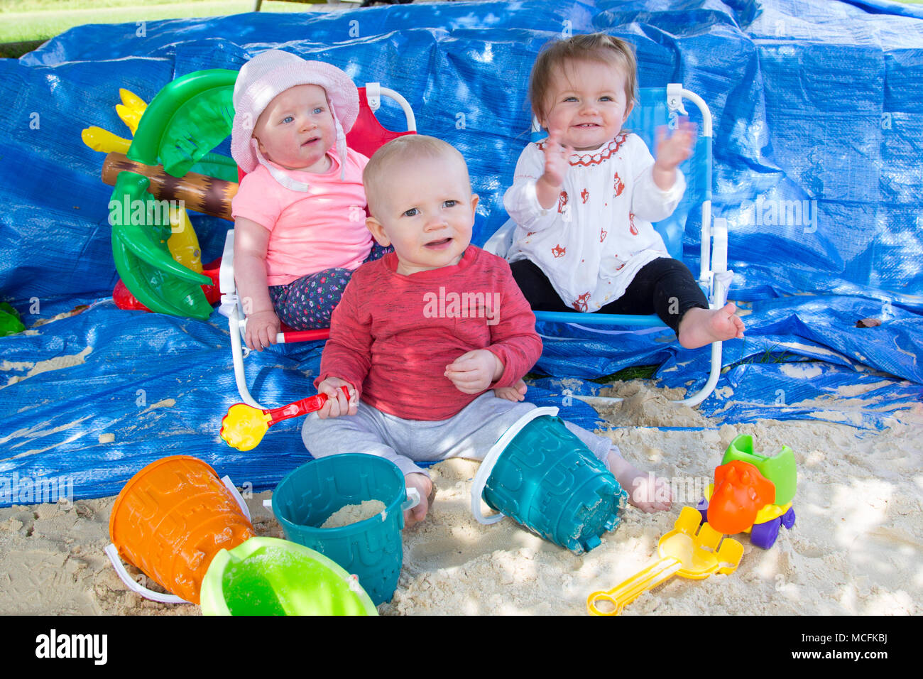 Toddlers playing with sand Stock Photo Alamy