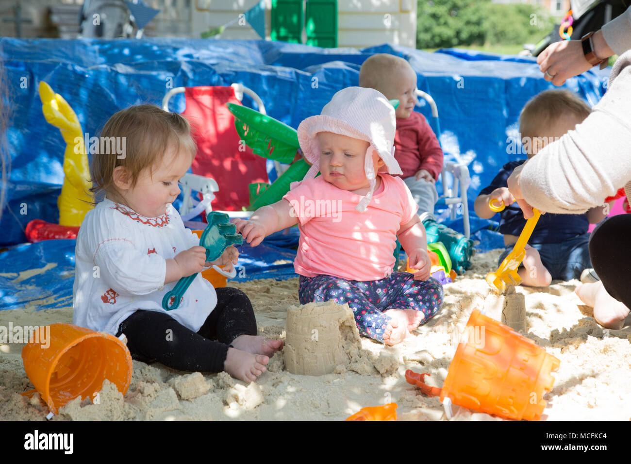 Toddlers playing with sand Stock Photo Alamy