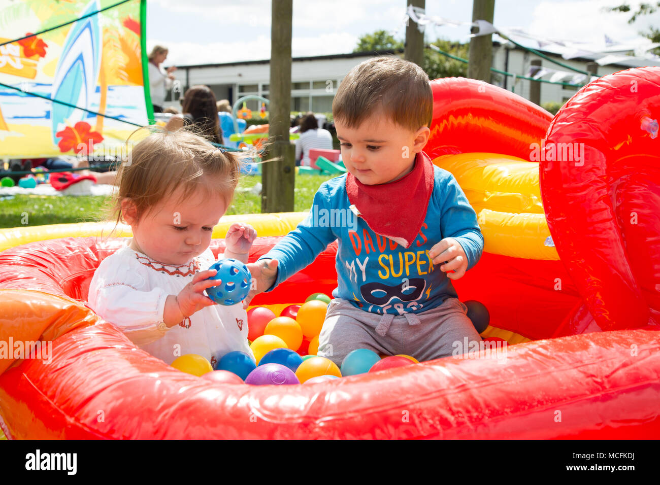 Babies playing with their toys Stock Photo Alamy