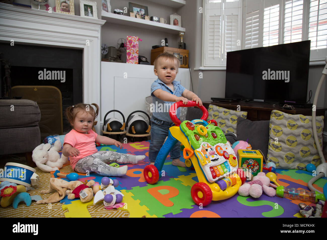 Babies playing with their toys Stock Photo Alamy