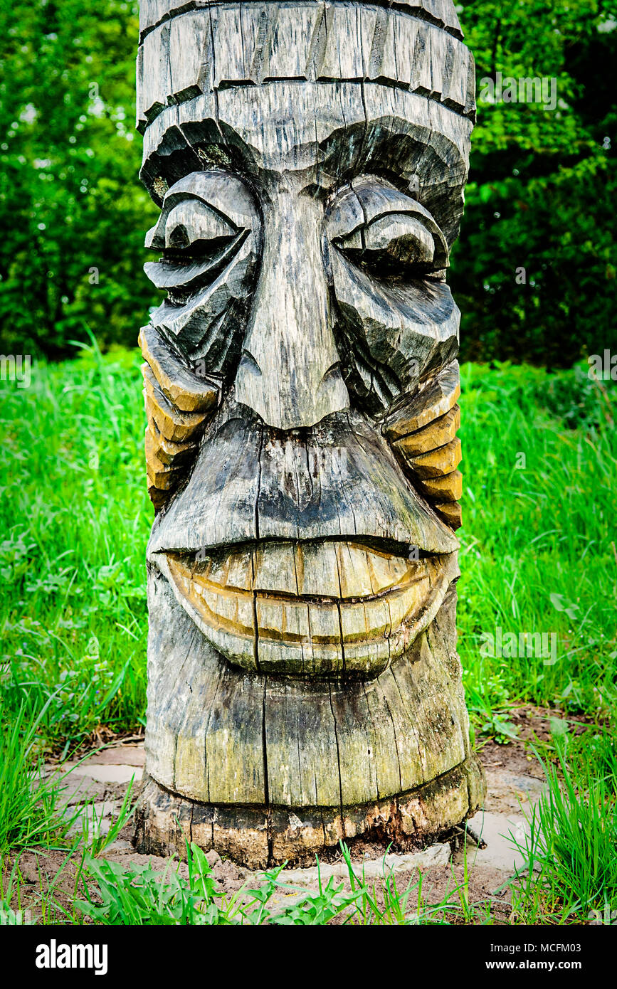 Wooden carving face on  totem pole, Indian Museum, Poland. Stock Photo
