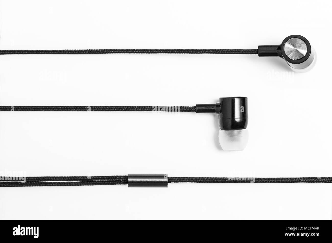 Silver black earphones in white background Stock Photo