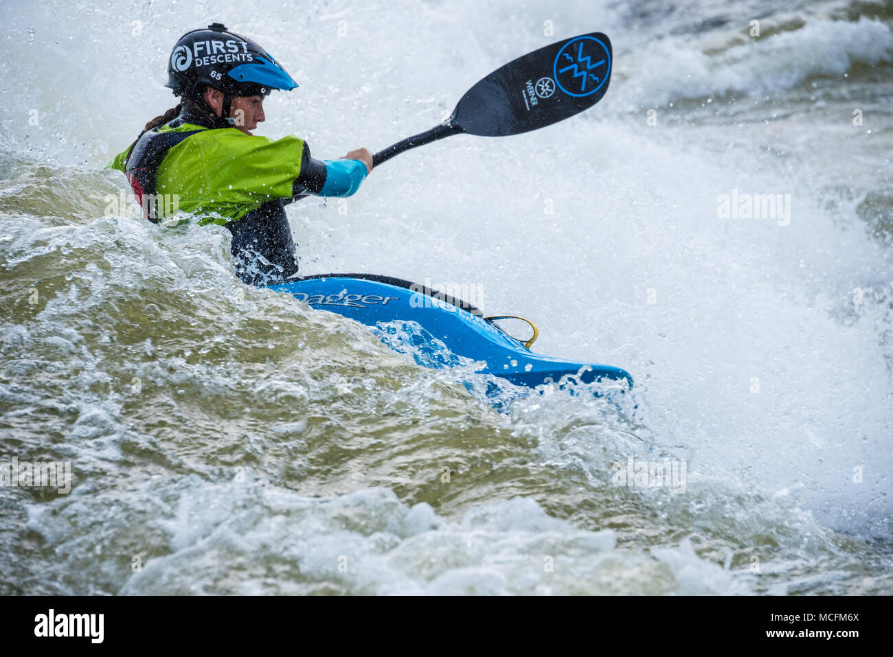 Female kayaker showing serious skills on the Chattahoochee River at