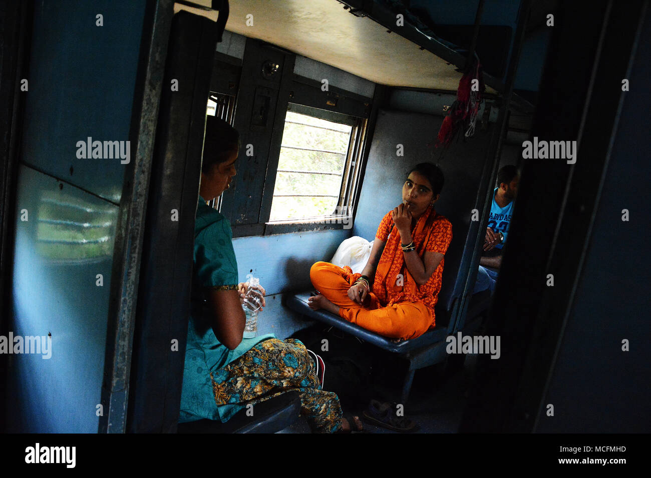 Family travelling on a train to Mumbai in India Stock Photo
