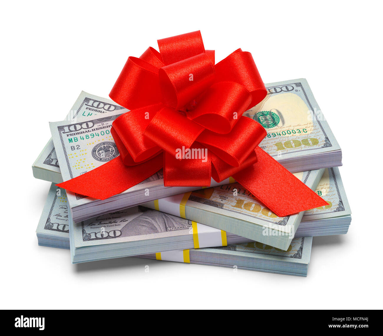 Pile of Money with a Red Gift Bow Isolated on a White Background. Stock Photo