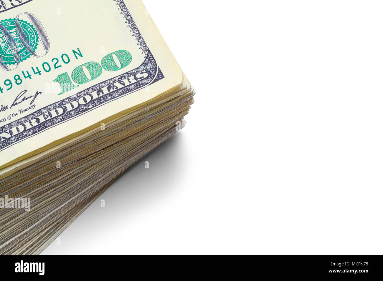 Close Up of a Stack of Hundred Dollar Bills Isolated on White. Stock Photo
