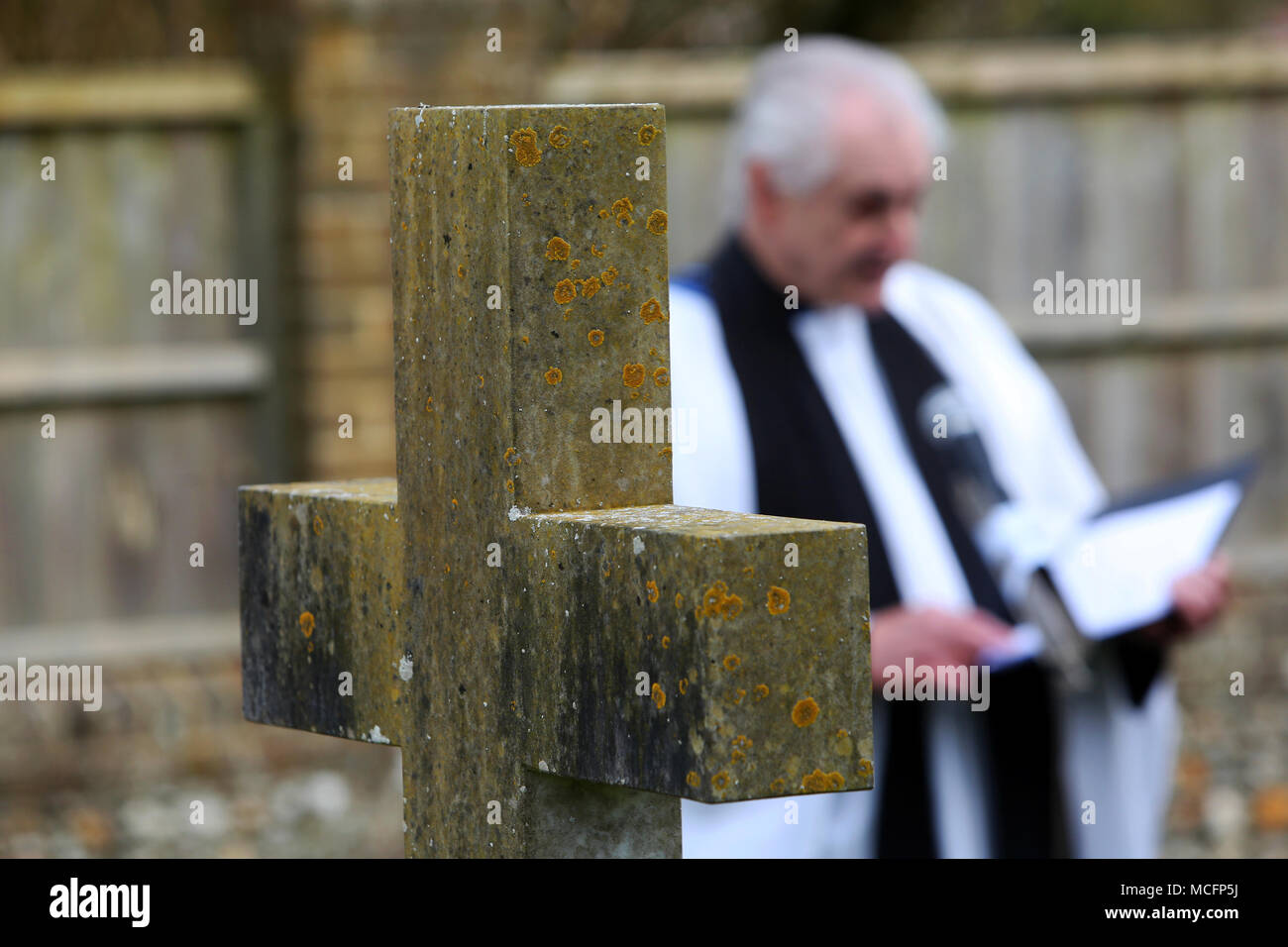 Vicar pictured in a church yard in Tangmere near Chichester, West Sussex, UK. Stock Photo