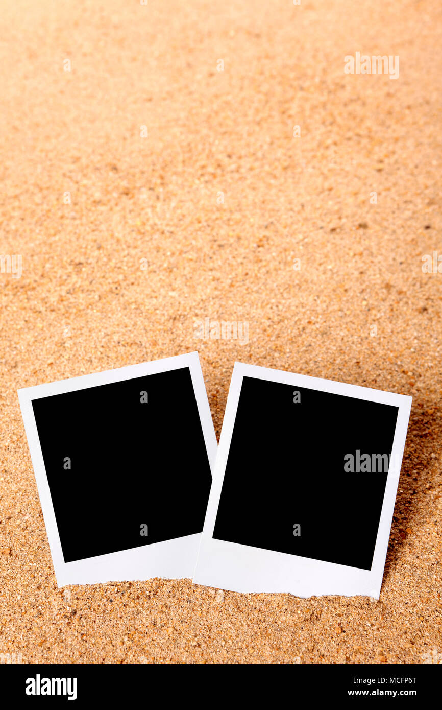 Instant camera photo frame prints on a beach sand background vertical