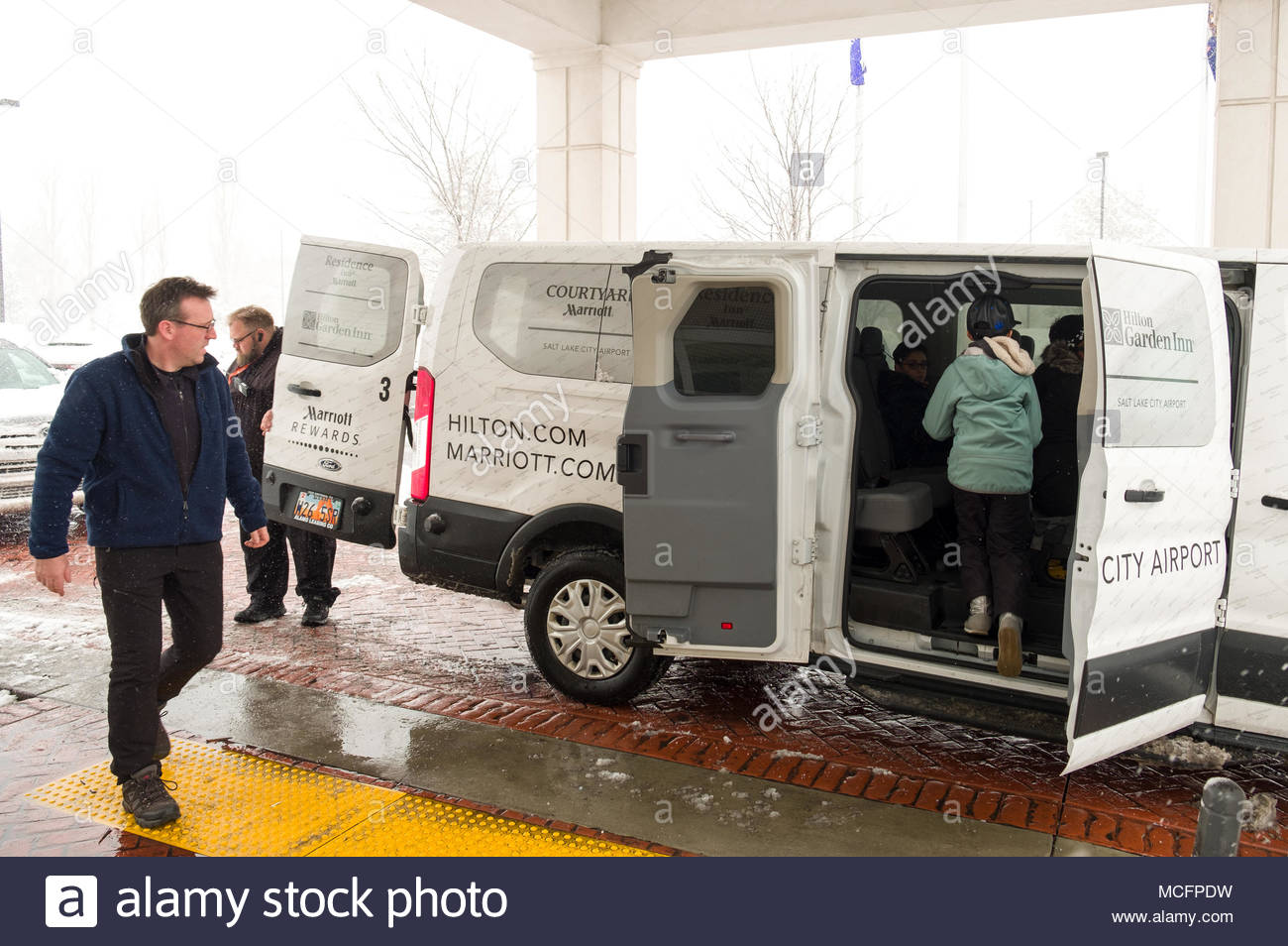 People Entering Hotel Shuttle Van At The Hilton Garden Inn Salt