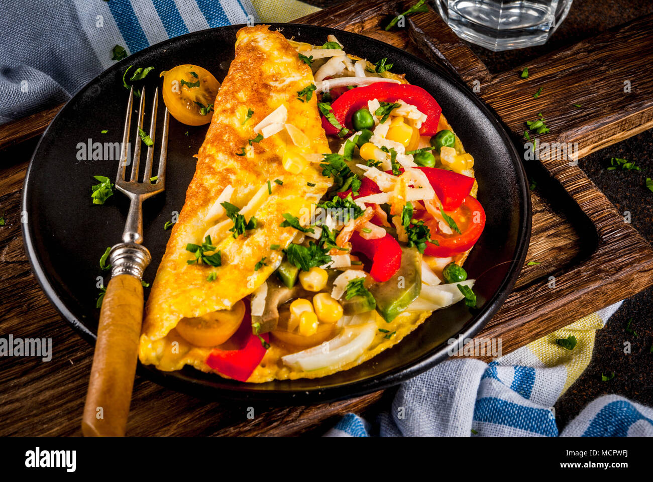 Healthy breakfast food, Stuffed egg omelette with vegetable, dark concrete background copy space Stock Photo