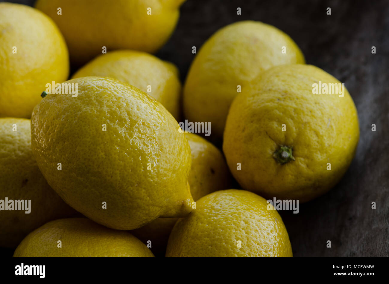 Group of lemons on the dark wooden surface Stock Photo
