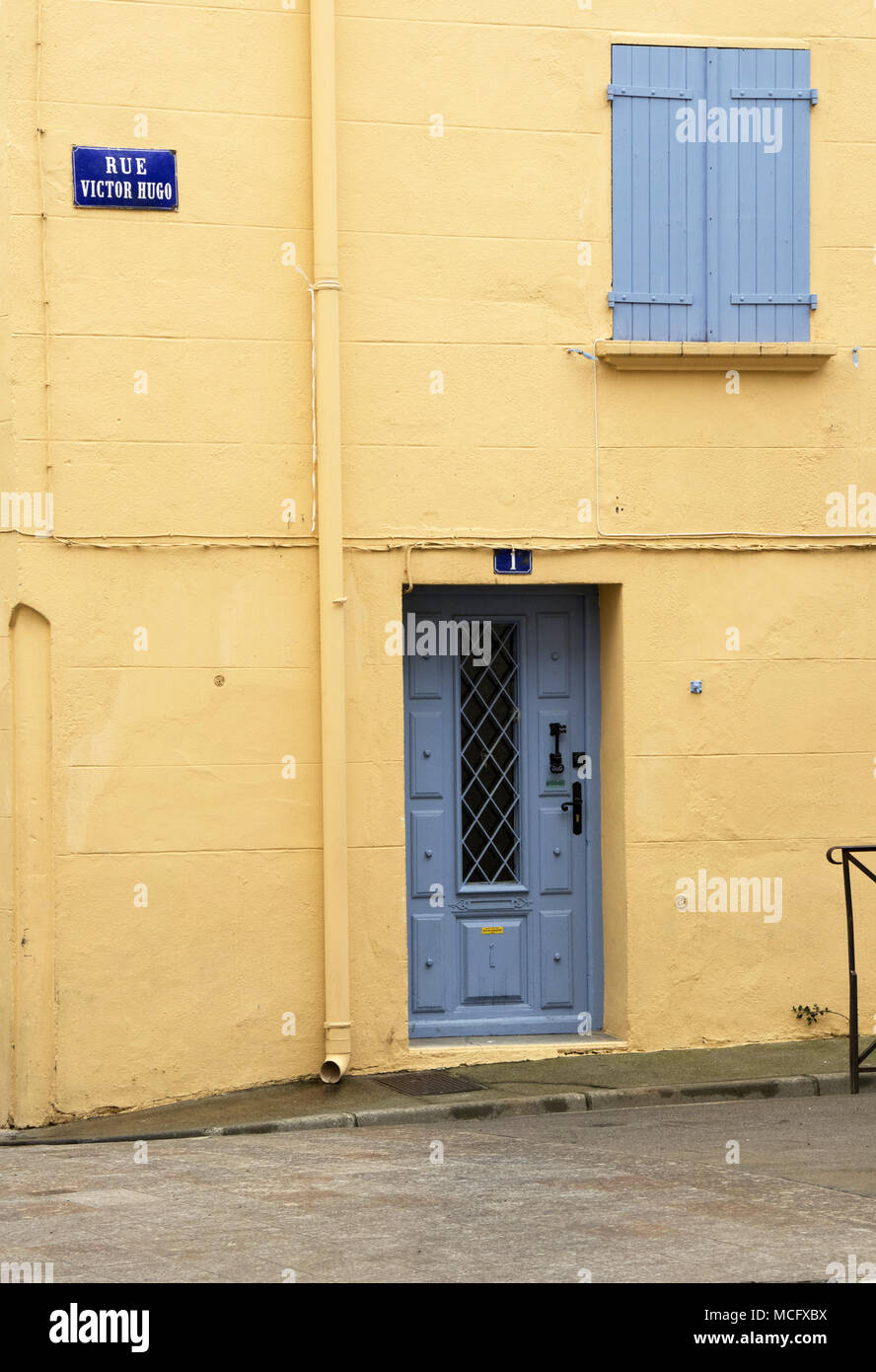 House In Ceret With Yellow Painted Wall And Blue Shutters And