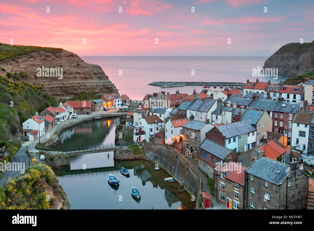 View over fishing village on east coast at sunrise, Staithes, North Yorkshire, England, United Kingdom, Europe Stock Photo