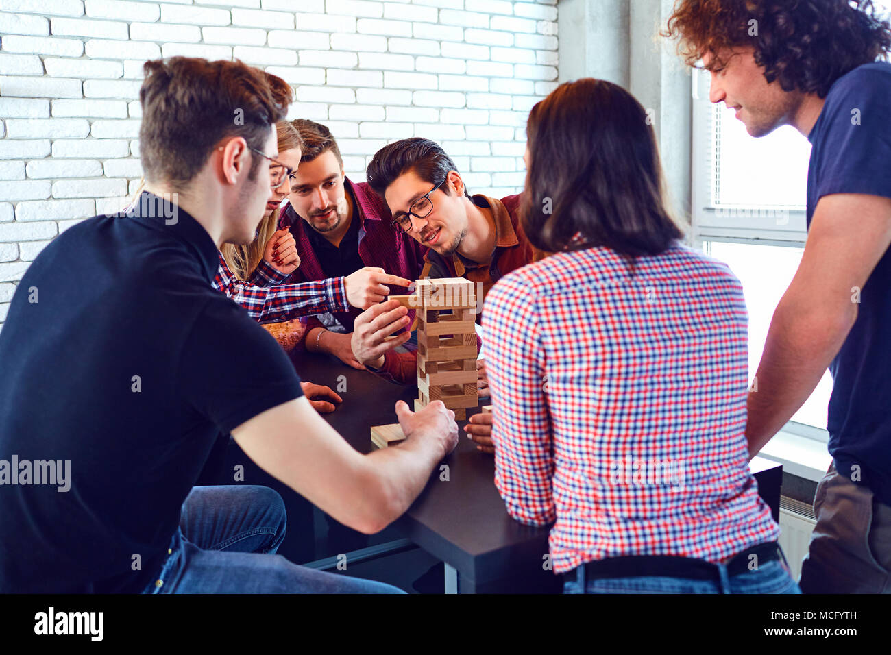 A group of friends play board games in the room Stock Photo - Alamy