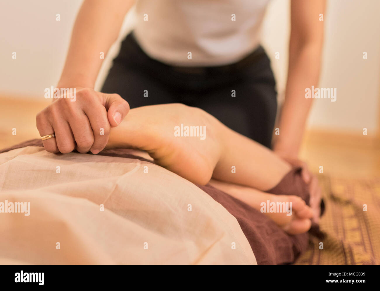 Thai Foot Massage in Wellness Spa Studio from young women to young women Stock Photo