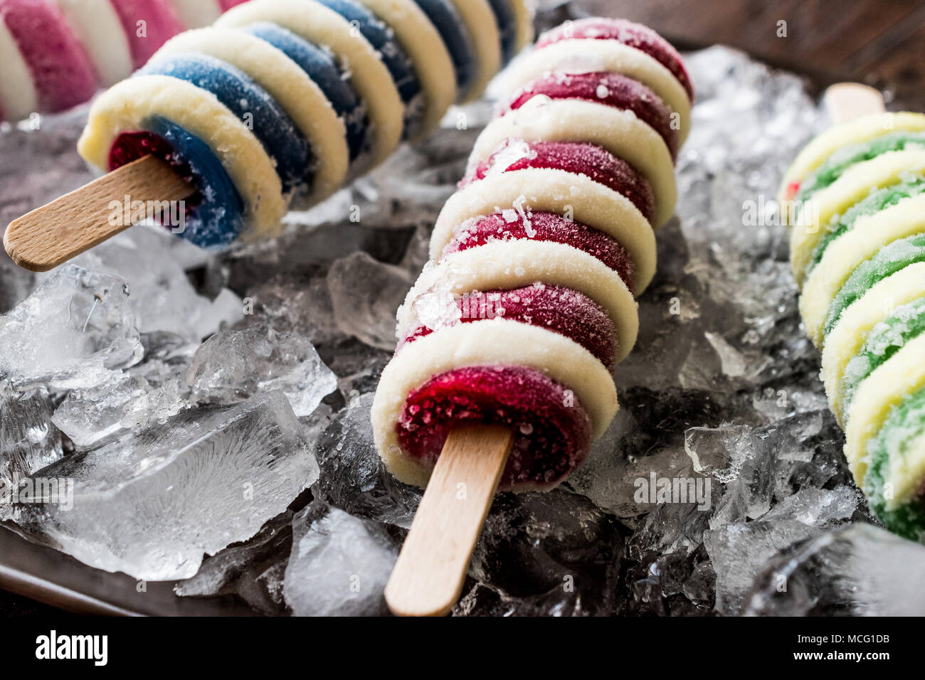 Popsicles ice cream with ice on dark surface. Summer Dessert Concept