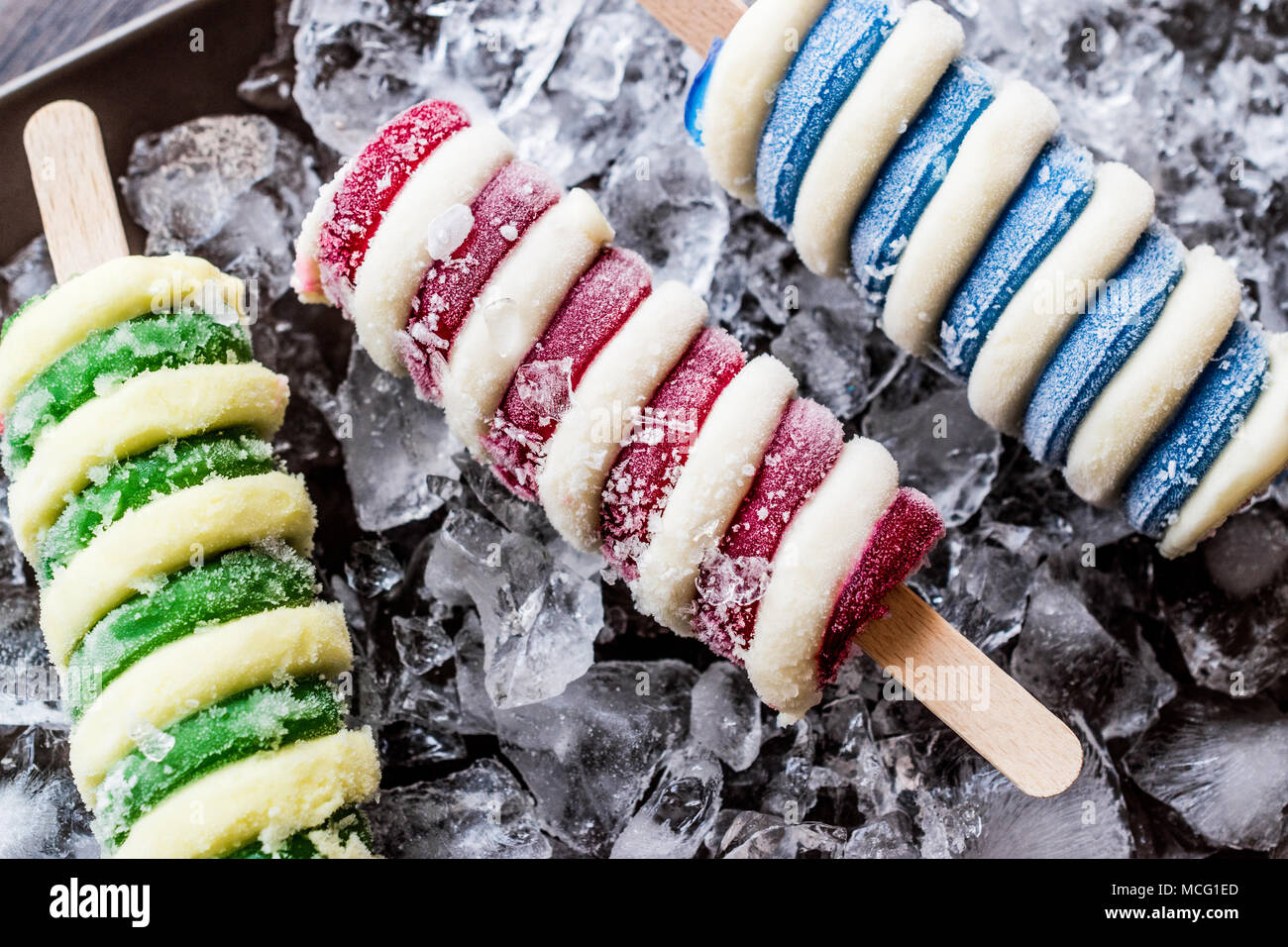 Popsicles ice cream with ice on dark surface. Summer Dessert Concept