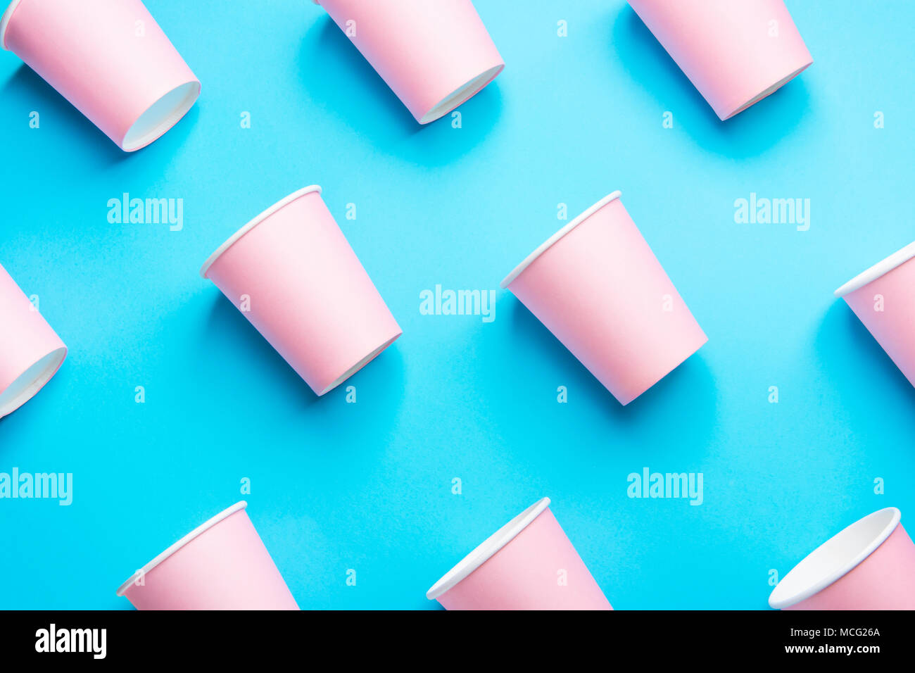 Pattern from Pink Paper Drinking Cups Arranged Diagonally on Mint Blue Backgrounds. Birthday Party Celebration Abstract Fashion Baby Shower Concept. P Stock Photo