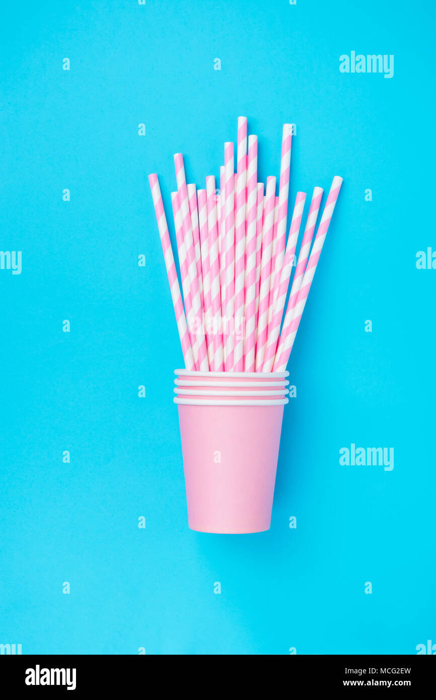 Stacked Drinking Paper Cups with Striped Straws on Mint Blue Background ...