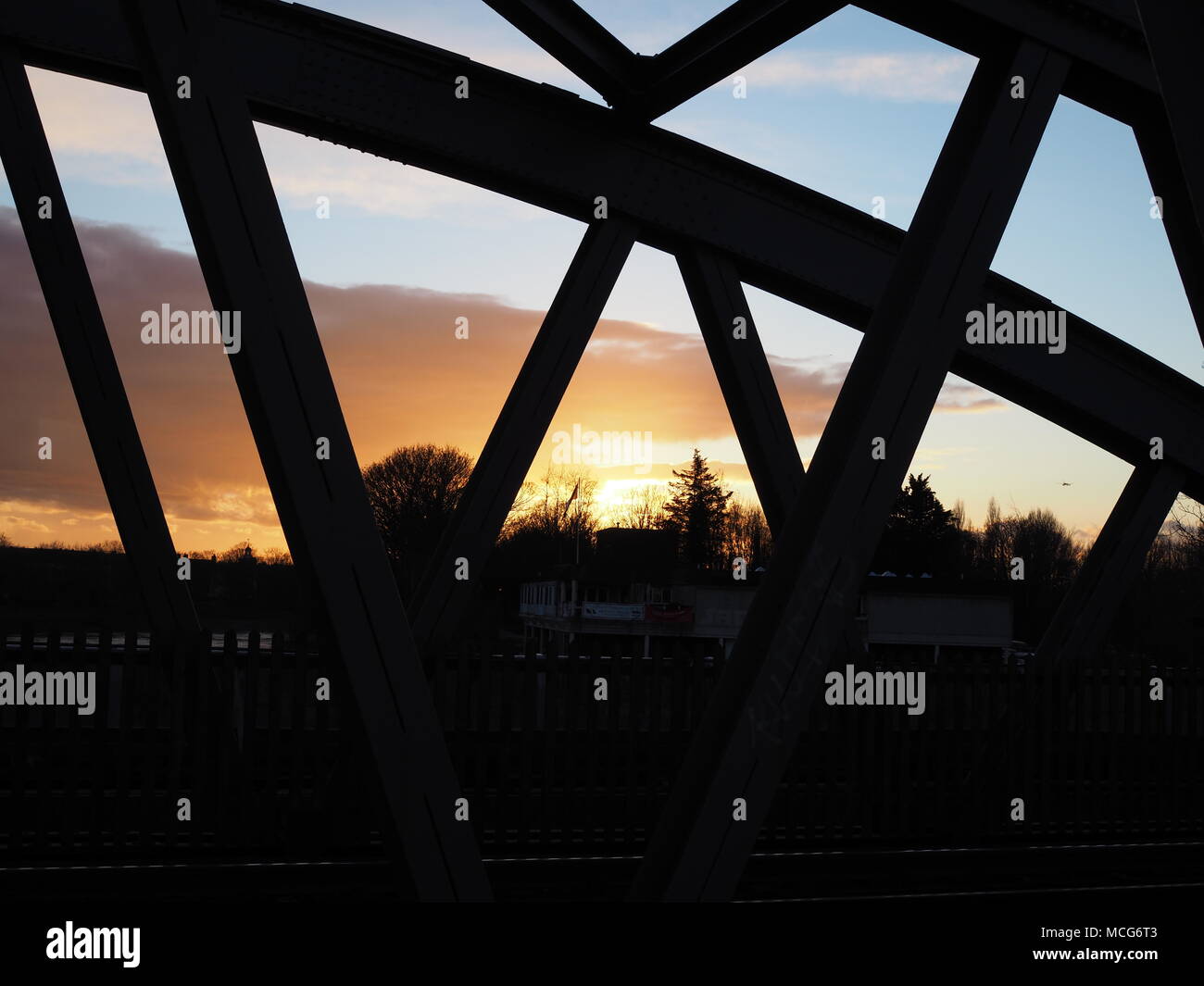 Sunset in Background of Silhouette of Barnes Bridge Stock Photo
