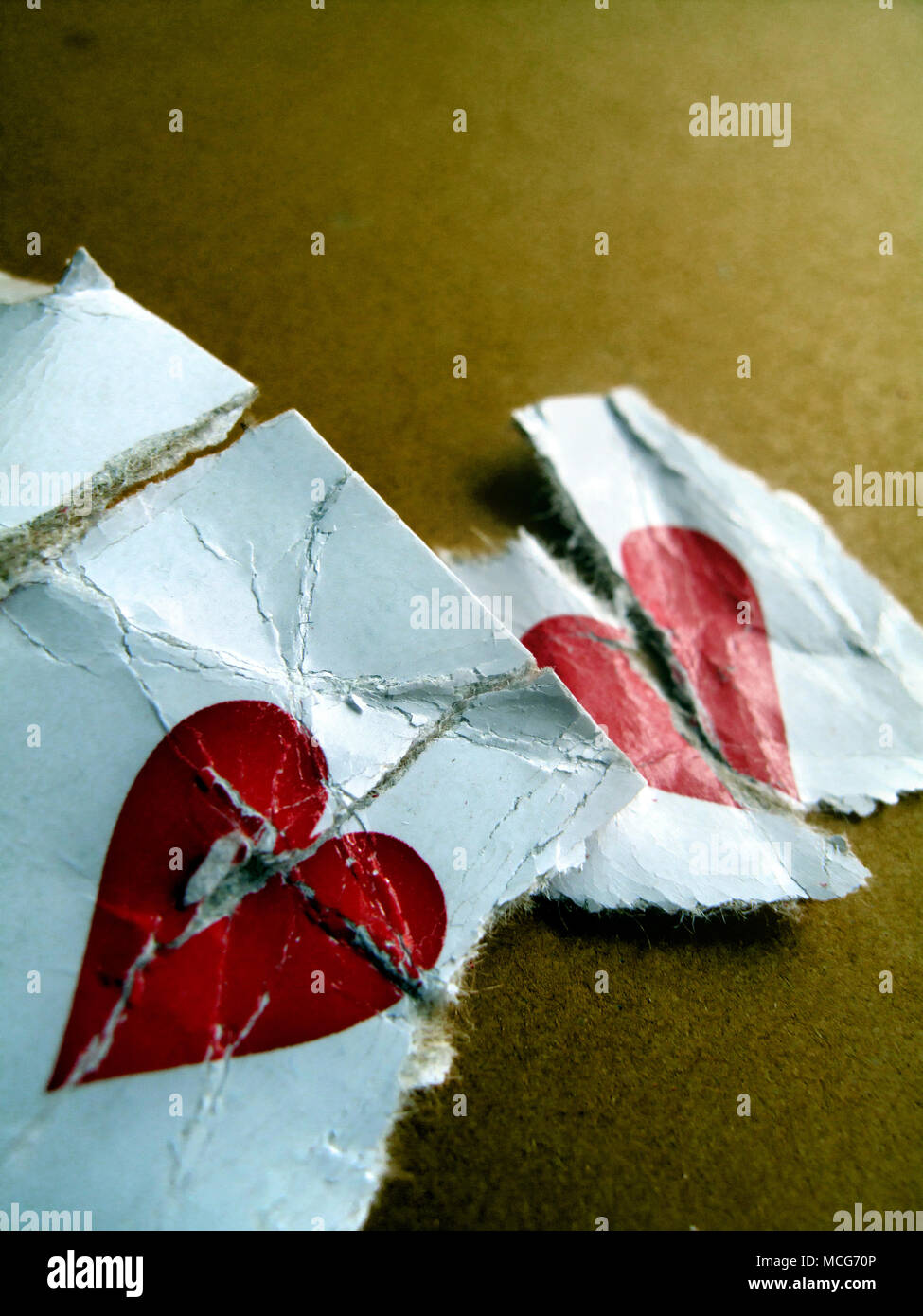 Section of a  playing card showing two broken red hearts. Stock Photo