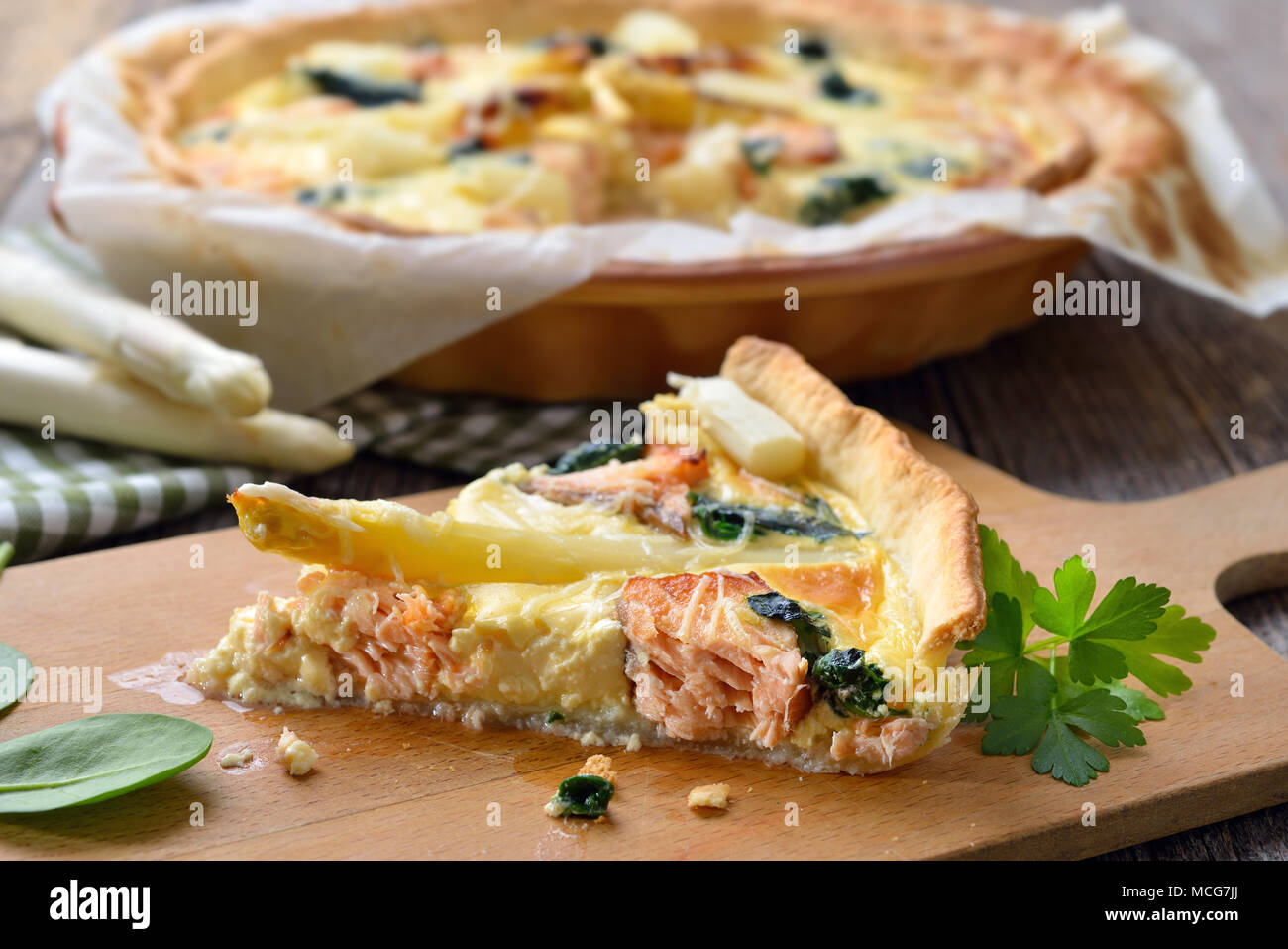 Baked quiche with fresh white asparagus, smoked salmon and spinach