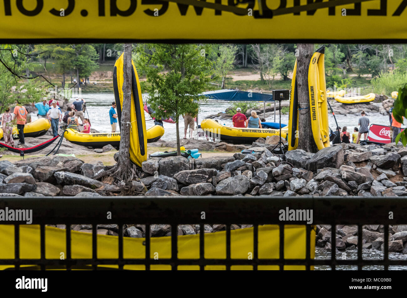 Whitewater rafts abound at Paddle South in Columbus, GA as spectators gather for the USA Freestyle Kayak National Championship. Stock Photo