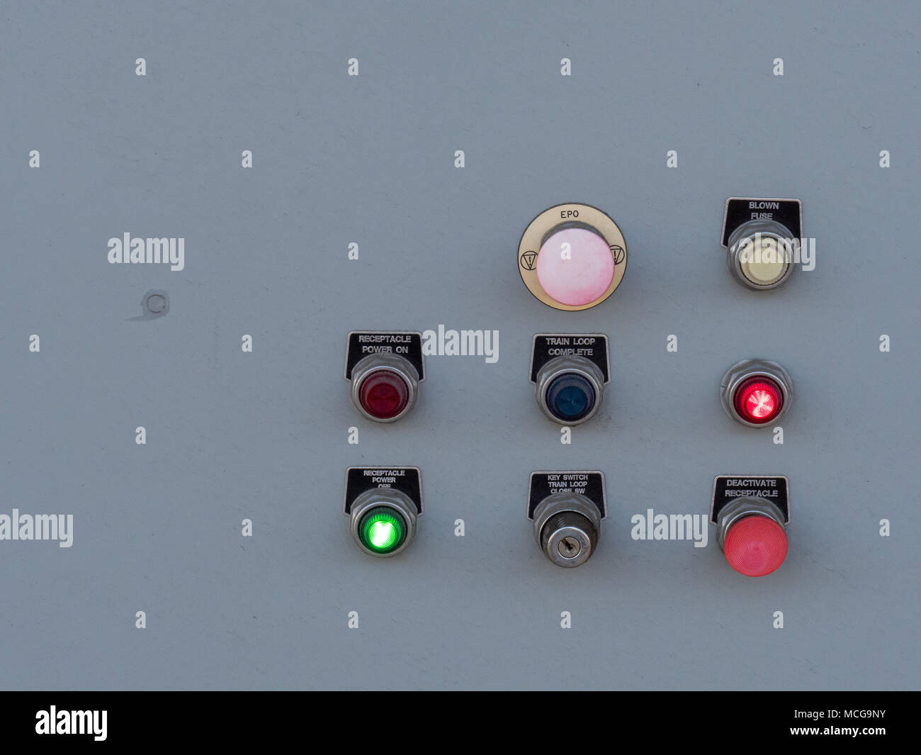 Switches and toggles on a control panel flashing various lights and
