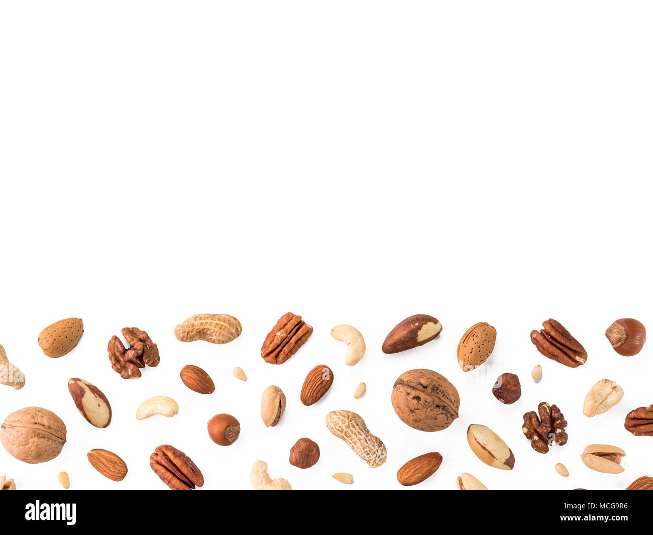Pattern of nuts mix with copy space. Various nuts isolated on white. Pecan, macadamia, brazil