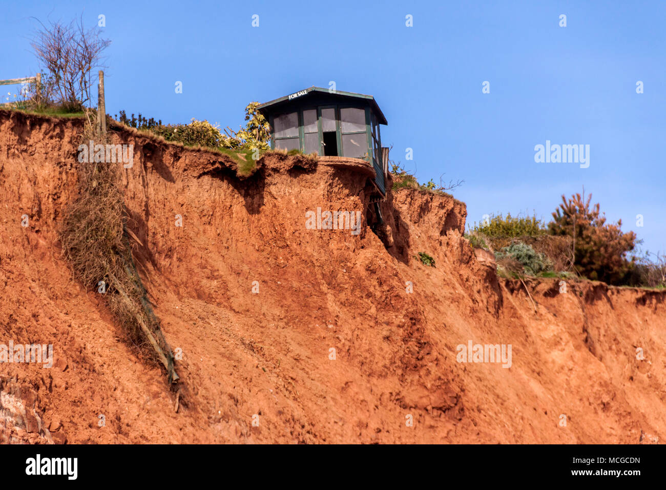 Sidmouth, Devon. 16th Apr 2018. UK Weather: Another rockfall - but still the 'Sidmouth Shed' hangs onto it's precarious perch. The whole town waits in anticipation.... Stock Photo