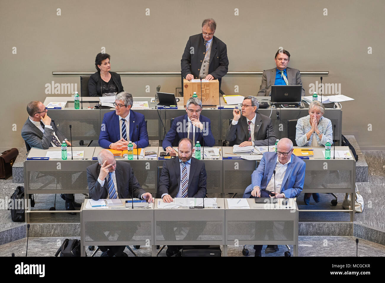 Chur, Switzerland, 16th April 2018. President of the parliament Martin Aebli during his opening speech at the April 2018 session in the Grand Council of the Canton of Grisons in Chur. (Back row left to right: Tina Gartmann, Martin Aebli, Domenic Gross; Middle row left to right: Christian Rathgeb, Jon Domenic Parolini, Mario Cavigelli, Martin Jäger, Barbara Janom Steiner; Front row left to right: Roland Kunfermann, Kenneth Danuser, Adrian Steiger) Credit: Rolf Simeon/Alamy Live News Stock Photo