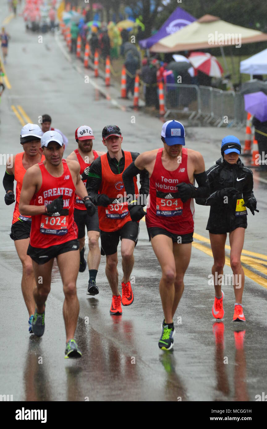 Newton, MA, USA April 16, 2018 Marathon runner tackle the stormy weather and the grueling uphill of Heartbreak Hill to complete the Boston Marathon Credit: James Kirkikis/Alamy Live News Stock Photo