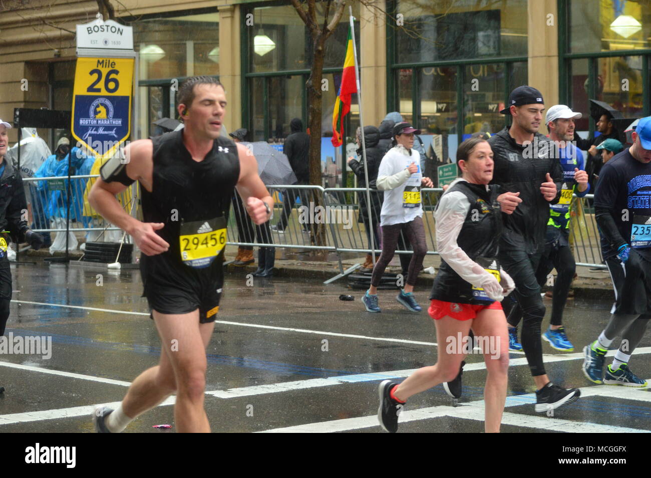 Boston, MA, USA April 16, 2018 Marathoin runners brave the cold, wind and rain as they approach the 26 mile marker in the Boston Marathon Credit: James Kirkikis/Alamy Live News Stock Photo