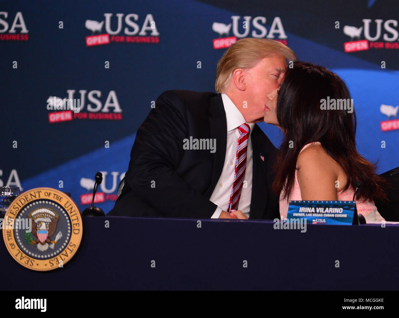 Hialeah, FL, USA. 16th Apr, 2018. U.S. President Donald J. Trump giving Irena Vilarino a kiss on the cheek while taking part in a roundtable discussion on tax cuts reform for Florida Small Businesses at Bucky Dent Park Gymnasium on April 16, 2018 in Hialeah, Florida. Credit: Mpi10/Media Punch/Alamy Live News Stock Photo