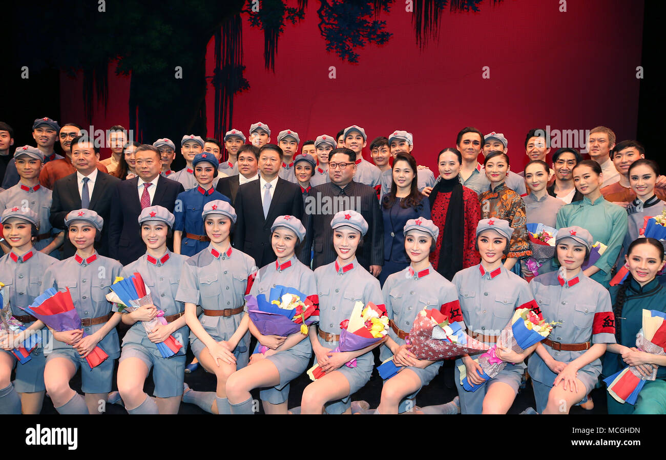 Pyongyang, Democratic People's Republic of Korea. 16th Apr, 2018. Kim Jong Un, top leader of the Democratic People's Republic of Korea, and his wife Ri Sol Ju pose for a group photo with dancers after watching the ballet 'The Red Detachment of Women' performed by a visiting Chinese art troupe in Pyongyang, the Democratic People's Republic of Korea, April 16, 2018. Credit: Yao Dawei/Xinhua/Alamy Live News Stock Photo
